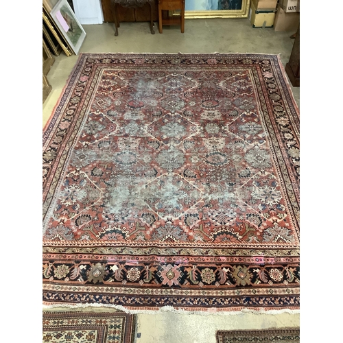 1046 - An early 20th century Heriz brick red ground carpet (worn), 418 x 330cm