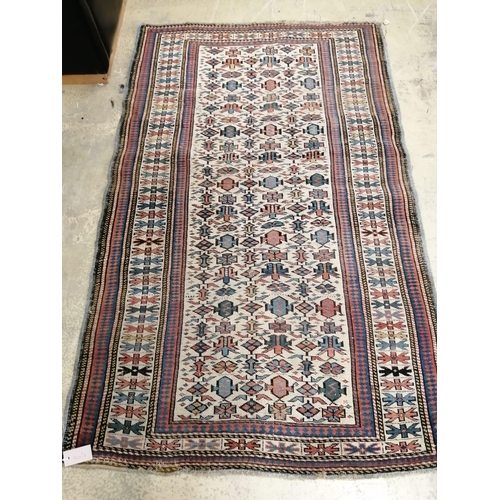 1099 - An antique Kuba ivory ground rug, 170 x 103cm