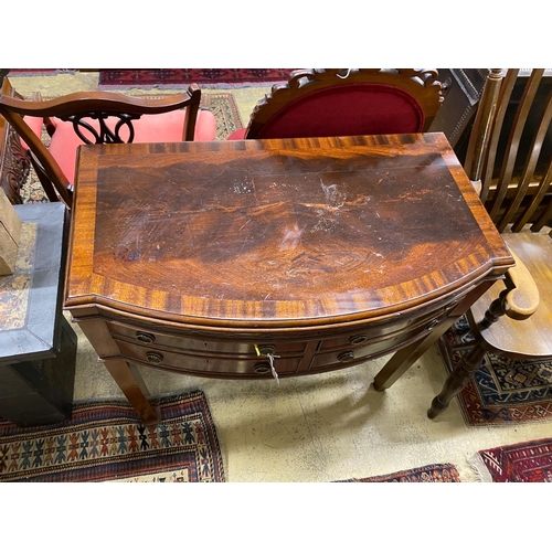 1100 - An early 20th century matched silver plated part canteen, in mahogany bow front four drawer table ca... 