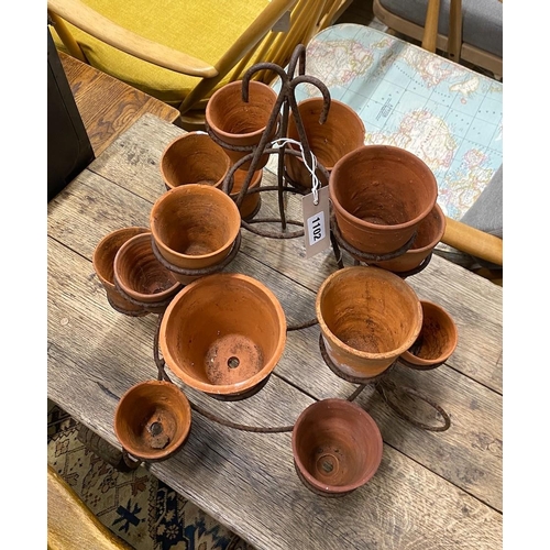 1102 - Fifteen small terracotta pots on wrought iron stand, height 52cm