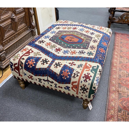 1194 - A large rectangular coffee table / footstool with antique kelim upholstery on stained turned beech f... 