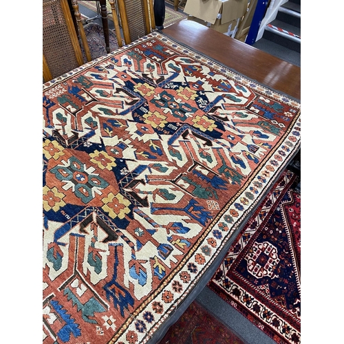 1195 - An antique Caucasian ivory ground Karabagh triple medallion rug, 224 x 130cm