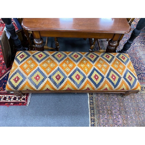 1200 - A William IV mahogany stool with polychrome kilim upholstered seat width 164cms, depth 59cms, height... 