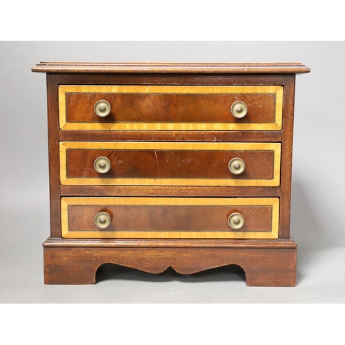 1259 - A miniature inlaid mahogany chest, 29cms wide x 25.5 cms high