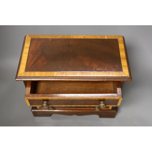 1259 - A miniature inlaid mahogany chest, 29cms wide x 25.5 cms high