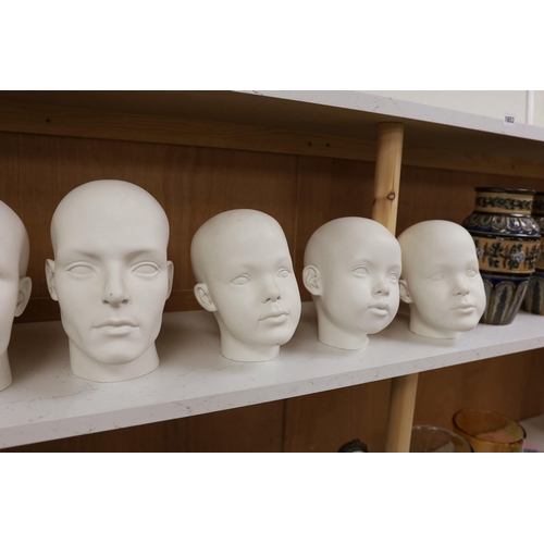 1261 - A set of seven fibreglass mannequin heads, largest 23cms high