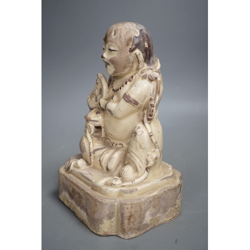 1329 - A Chinese Cizhou seated figure of Liu Hai, possibly Ming dynasty, 21cms high, glaze flaking