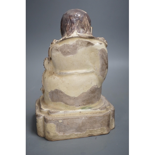 1329 - A Chinese Cizhou seated figure of Liu Hai, possibly Ming dynasty, 21cms high, glaze flaking