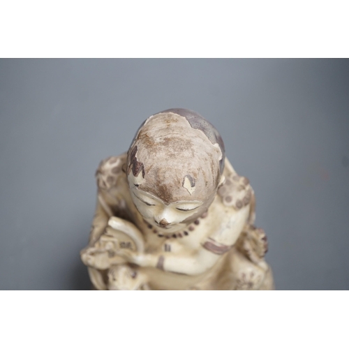 1329 - A Chinese Cizhou seated figure of Liu Hai, possibly Ming dynasty, 21cms high, glaze flaking