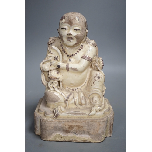 1329 - A Chinese Cizhou seated figure of Liu Hai, possibly Ming dynasty, 21cms high, glaze flaking