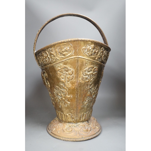 1356 - An embossed brass helmet coal bucket, 48cms high