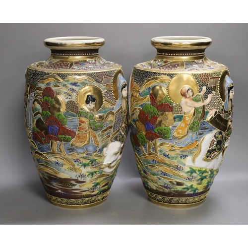 1361 - A pair of Japanese moulded and moriage decorated vases, 31cms