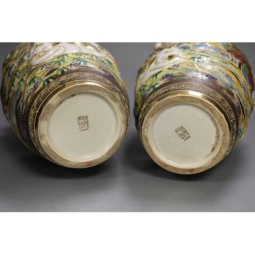 1361 - A pair of Japanese moulded and moriage decorated vases, 31cms