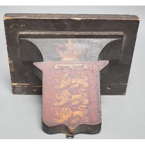 1375 - Four 19th century painted and ebonised heraldic wall brackets together with a 19th century armorial ... 