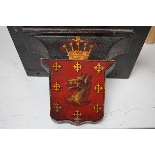 1375 - Four 19th century painted and ebonised heraldic wall brackets together with a 19th century armorial ... 