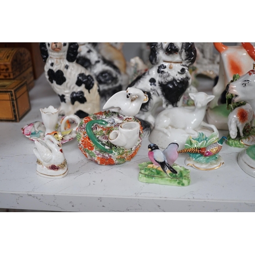 1380 - A quantity of Victorian Staffordshire animal figures, two pearlware putti and a Derby figure of a ch... 