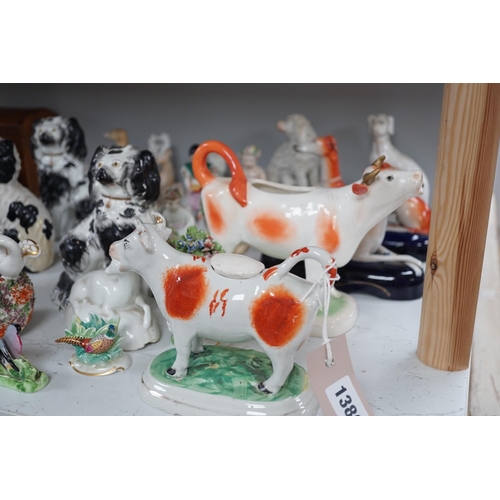 1380 - A quantity of Victorian Staffordshire animal figures, two pearlware putti and a Derby figure of a ch... 