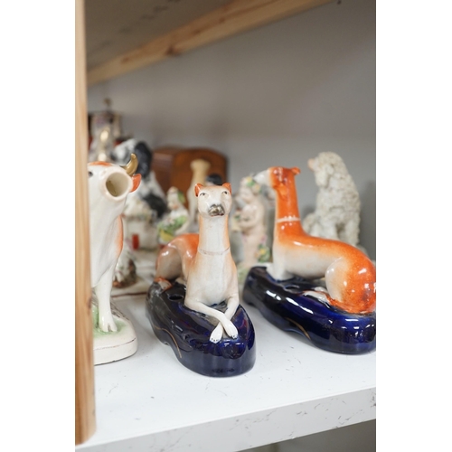 1380 - A quantity of Victorian Staffordshire animal figures, two pearlware putti and a Derby figure of a ch... 