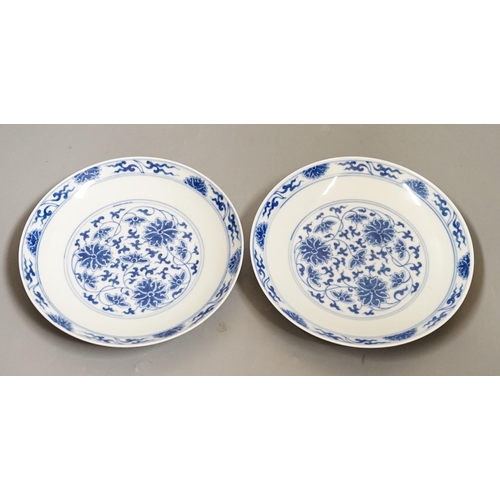 1475 - A pair of Chinese blue and 'white lotus' dishes, Qianlong marks, 16.5cms diameter