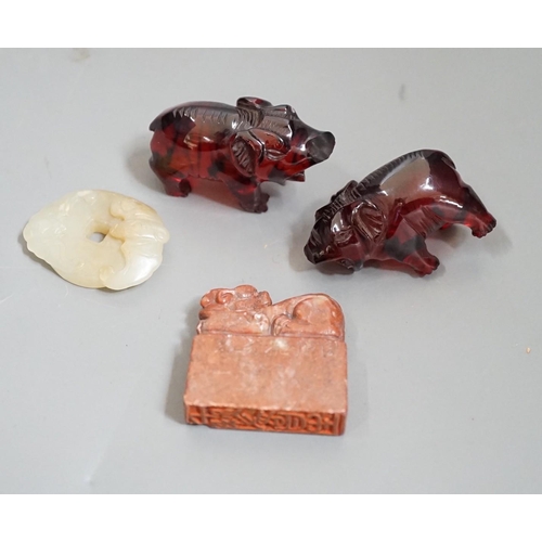 1483 - A Chinese Jade bi disc, two cherry amber ox and a soapstone seal