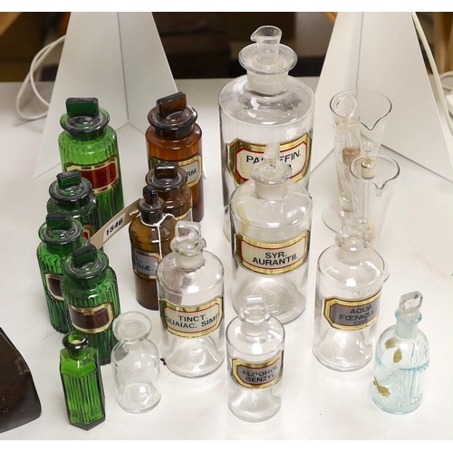 1546 - A collection of apothecary bottles, two measures and files, tallest bottle 27cms high,