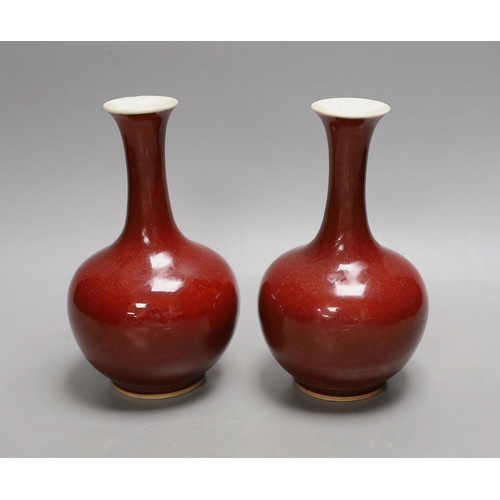 1550 - A pair of Chinese sang de boeuf glazed vases, early 20th century, 20cm high