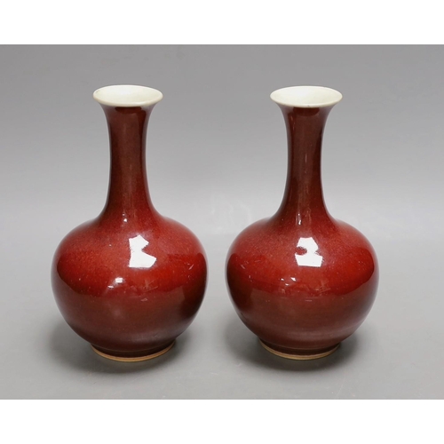 1550 - A pair of Chinese sang de boeuf glazed vases, early 20th century, 20cm high