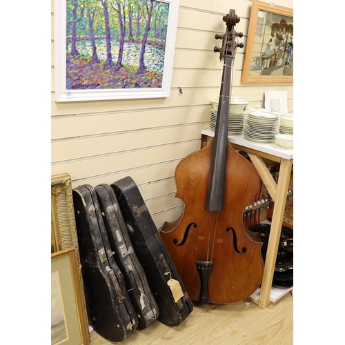 1556 - A double bass and three various violins, double bass 165cms high