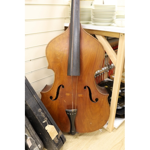 1556 - A double bass and three various violins, double bass 165cms high