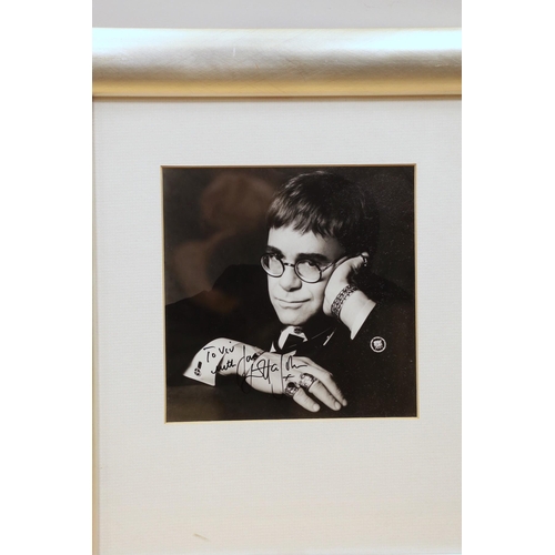 1557 - A collection of mostly framed autographs to include an event card from Elton John, 25 March 1994 sig... 