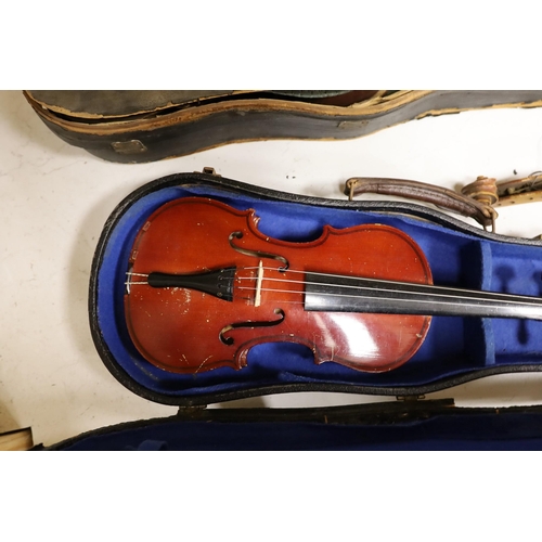 1559 - A German quarter size violin, a German violin a.f. and a modern violin