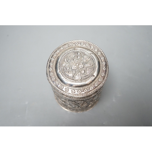 1803 - An Indian embossed white metal cigar case, 12.2cm and a similar canister and cover.