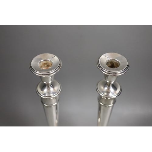 1833 - A pair of North American sterling candlesticks, with tapering stems, on circular bases, height 35.7c... 