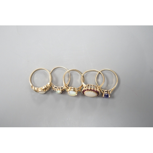 1877 - Five assorted modern 9ct gold and gem set dress rings, including white opal and garnet oval cluster,... 