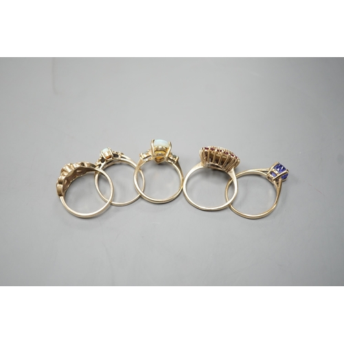 1877 - Five assorted modern 9ct gold and gem set dress rings, including white opal and garnet oval cluster,... 