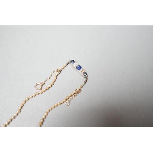 1878 - A single strand graduated natural saltwater pearl necklace, with sapphire and diamond set clasp, 44c... 