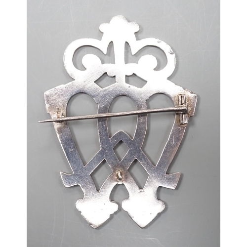 1879 - A white metal entwined twin heart brooch, with scrolling terminal, unmarked, 70mm.