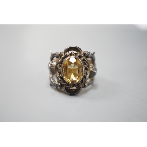 1880 - A 1960's silver and oval cut citrine set ring, the shank modelled and twin cupids, size O, gross wei... 