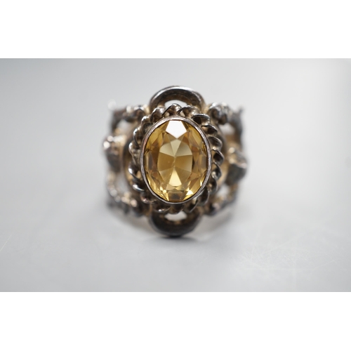 1880 - A 1960's silver and oval cut citrine set ring, the shank modelled and twin cupids, size O, gross wei... 