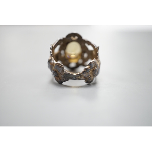 1880 - A 1960's silver and oval cut citrine set ring, the shank modelled and twin cupids, size O, gross wei... 