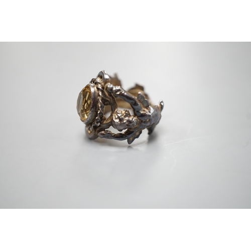 1880 - A 1960's silver and oval cut citrine set ring, the shank modelled and twin cupids, size O, gross wei... 