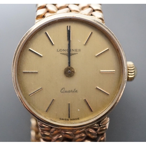 1883 - A lady's 9ct gold  Longines quartz wrist watch on an inegral 9ct gold bracelet, with Longines box, g... 