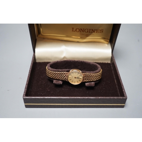 1883 - A lady's 9ct gold  Longines quartz wrist watch on an inegral 9ct gold bracelet, with Longines box, g... 