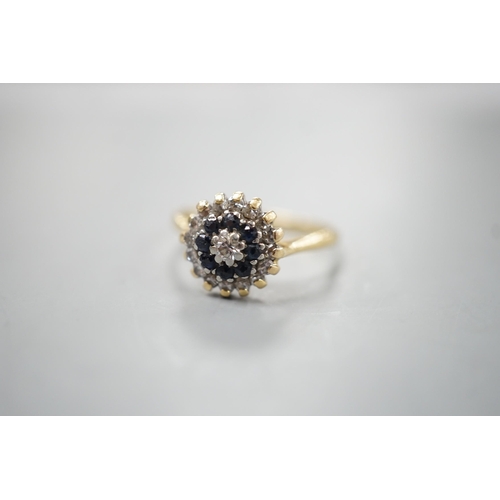 1913 - A 1960's 18ct gold, 18ct gold, sapphire and diamond set circular cluster ring, size O, gross weight ... 