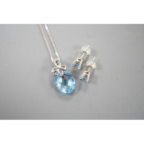 1924 - A modern 14k white metal, facetted pear cut blue topaz and diamond chip set pendant, 19mm, on a 750 ... 