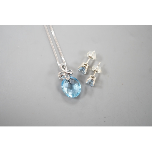 1924 - A modern 14k white metal, facetted pear cut blue topaz and diamond chip set pendant, 19mm, on a 750 ... 