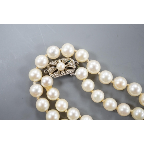 1928 - A long single strand cultured pearl necklace with cultured pearl set 9ct white gold clasp, 75cm.... 