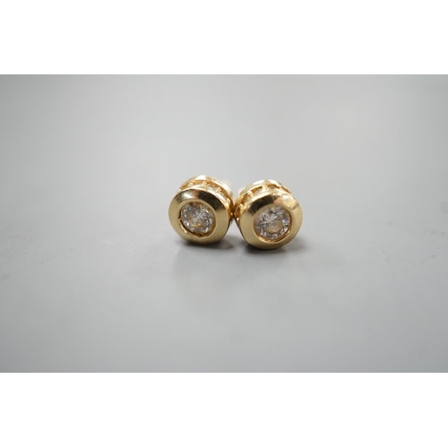 1938 - A modern pair of 14k yellow metal and single stone diamond set ear studs, with diamond chip setting,... 