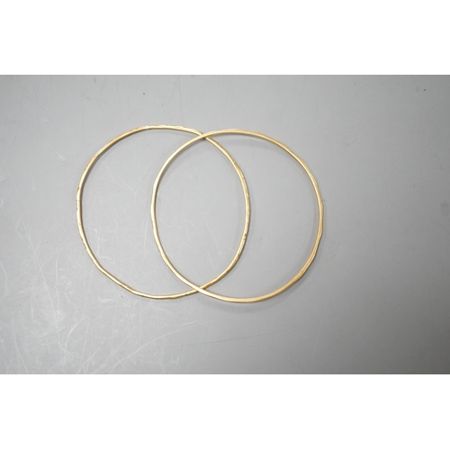 1939 - A pair of yellow metal child's bangles, diameter 58mm, 8.9 grams.