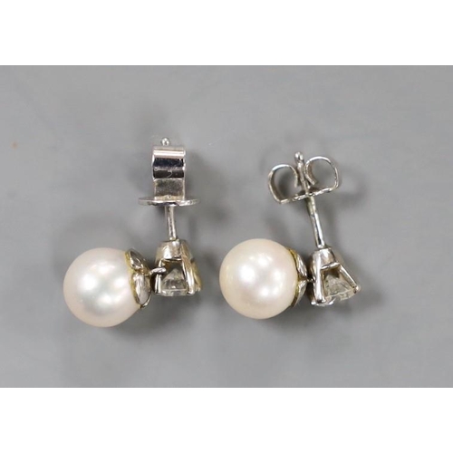 1947 - A pair of white metal cultured pearl and single stone diamond set ear studs (butterflies differ) pea... 